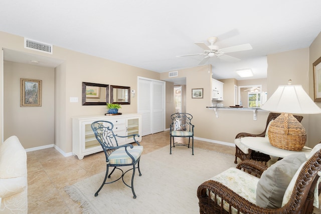 sitting room featuring ceiling fan