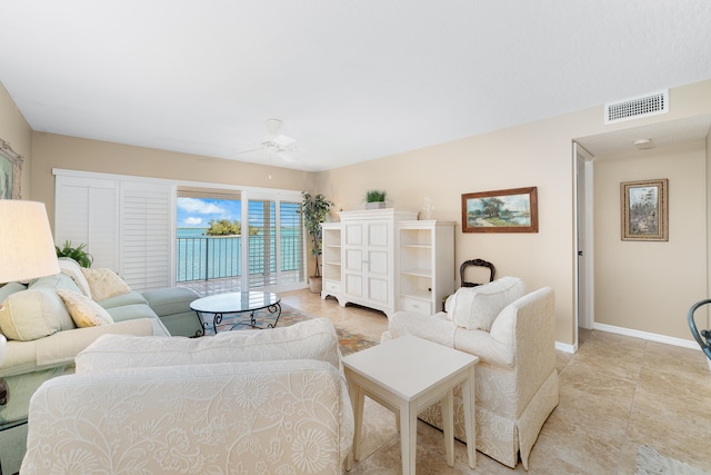 tiled living room with ceiling fan