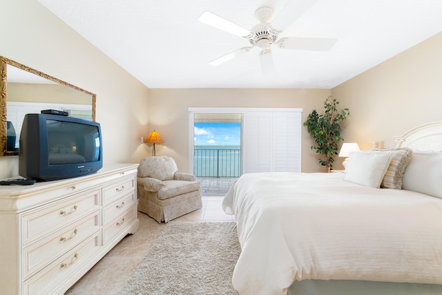 tiled bedroom with ceiling fan and access to exterior