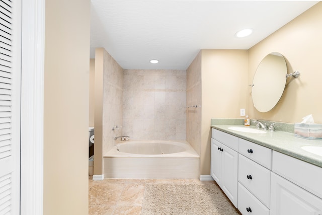 bathroom with a bathing tub, vanity, and toilet