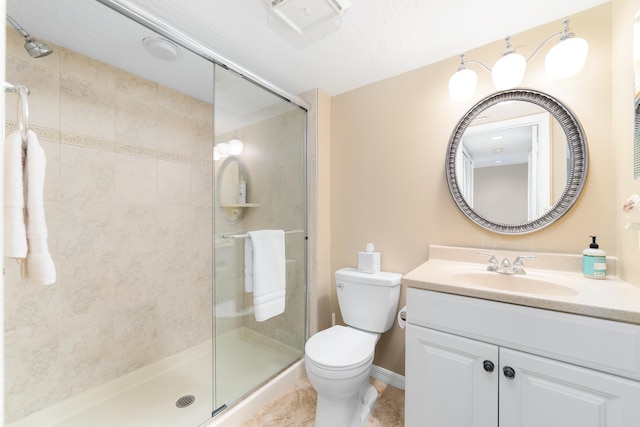 bathroom featuring tile patterned flooring, a shower with door, vanity, and toilet