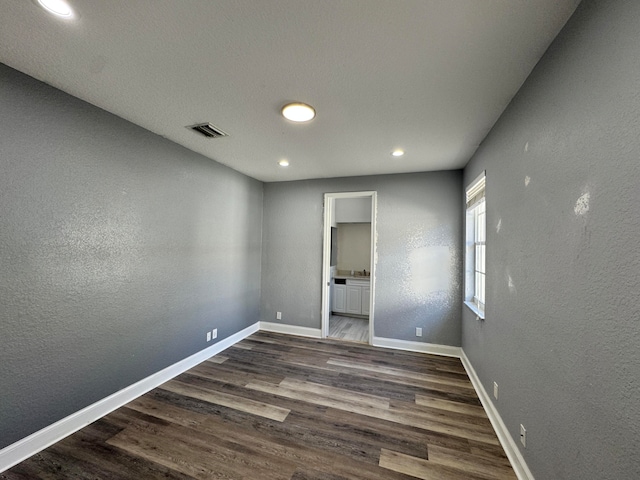 unfurnished room with dark hardwood / wood-style floors