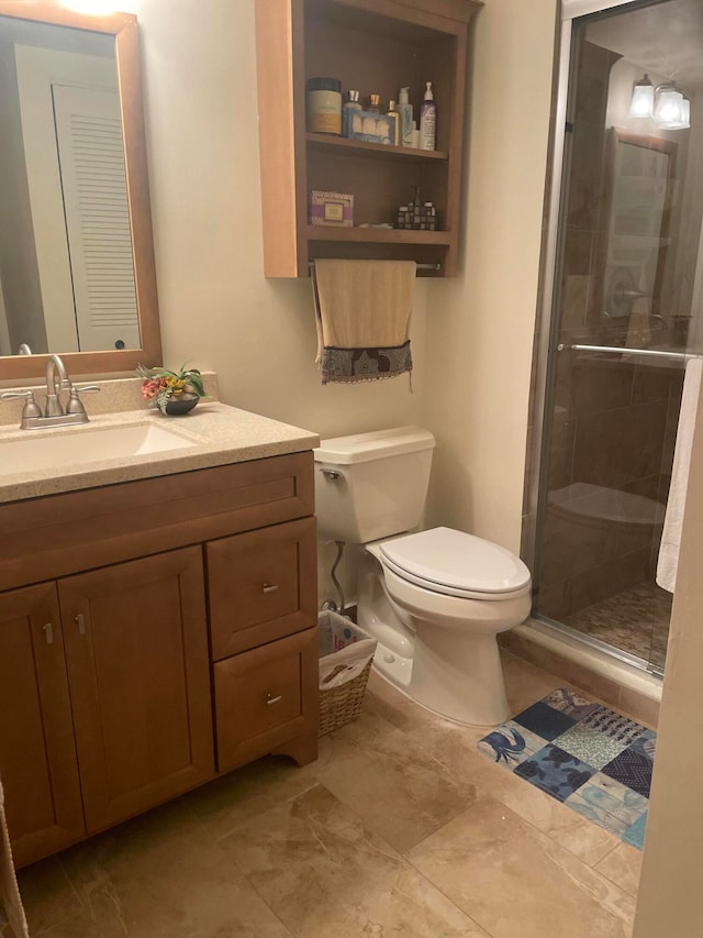 bathroom with toilet, vanity, and walk in shower