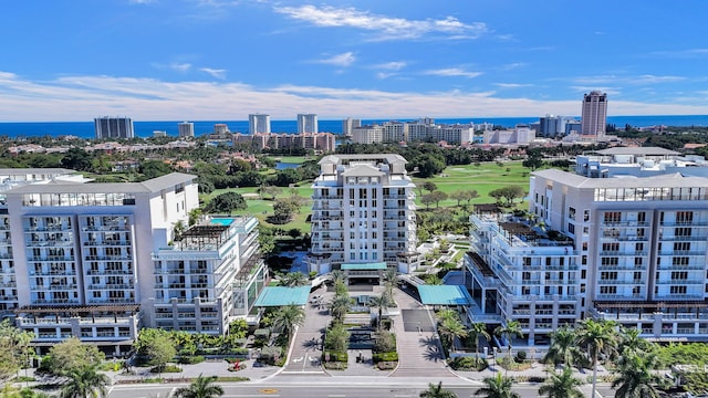 birds eye view of property featuring a city view and a water view