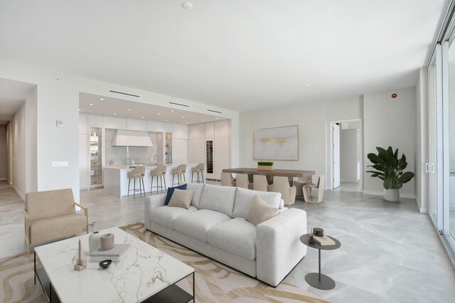 kitchen with expansive windows, modern cabinets, white cabinets, and a sink