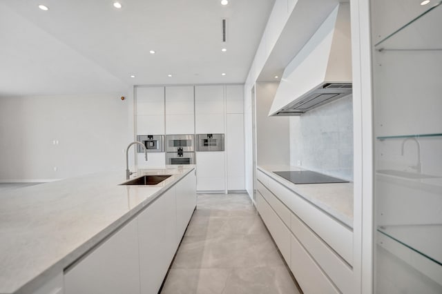 kitchen with premium range hood, modern cabinets, a sink, and black electric cooktop