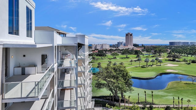 view of community featuring a water view, a view of city, stairs, and golf course view