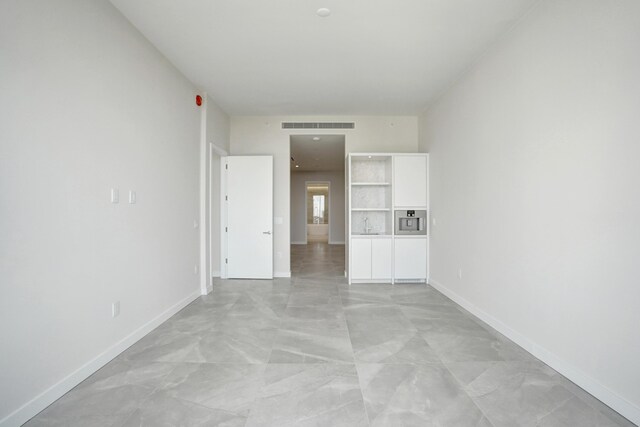 unfurnished room featuring concrete flooring, recessed lighting, and baseboards