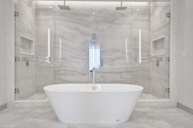 full bathroom with a soaking tub, marble finish floor, and a marble finish shower