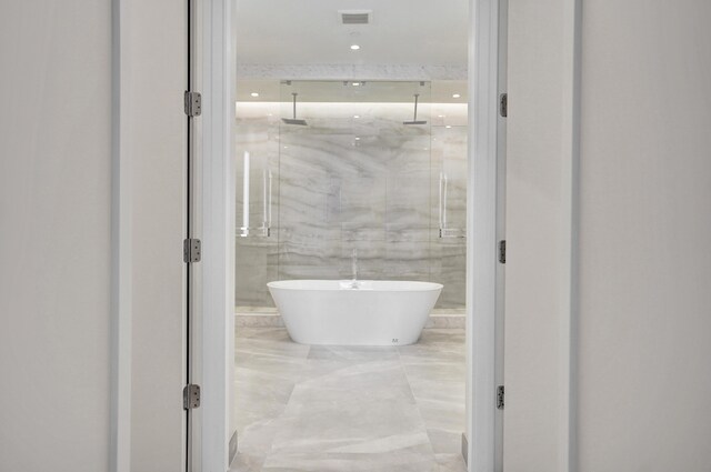 full bathroom featuring visible vents and a marble finish shower