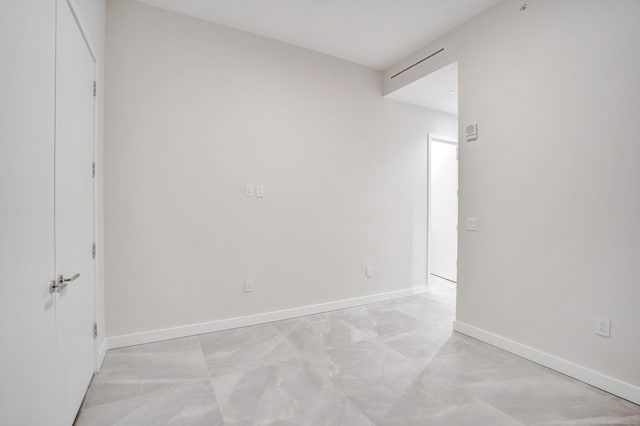 spare room featuring baseboards