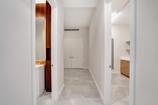 unfurnished room featuring floor to ceiling windows, visible vents, and baseboards