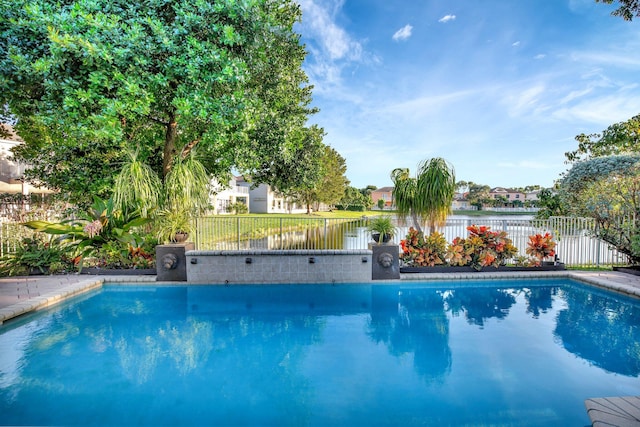 view of swimming pool with a water view