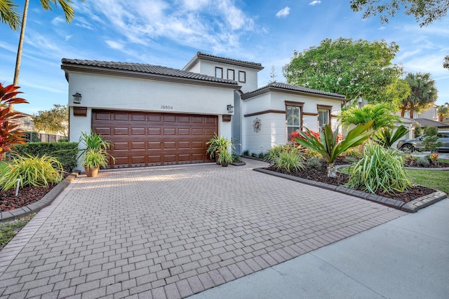 mediterranean / spanish house featuring a garage