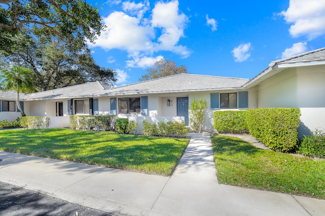 ranch-style home featuring a front yard