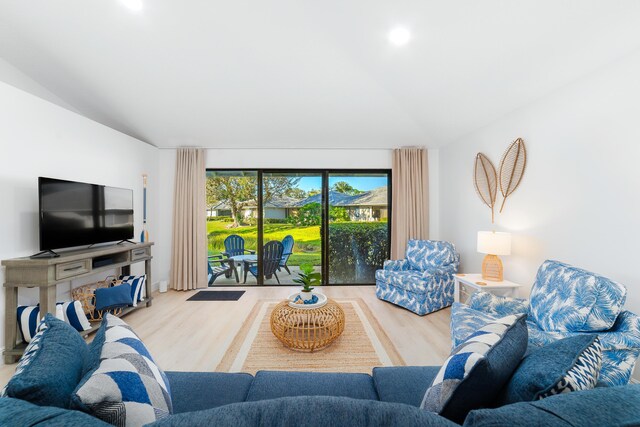 living room with lofted ceiling and light hardwood / wood-style floors