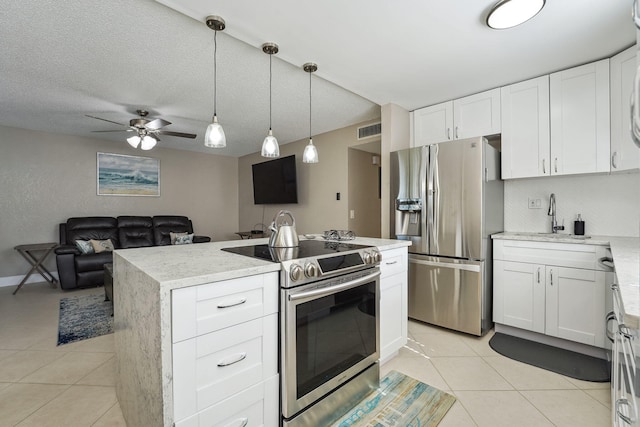 kitchen featuring stainless steel appliances, a kitchen island with sink, ceiling fan, light tile patterned floors, and white cabinets