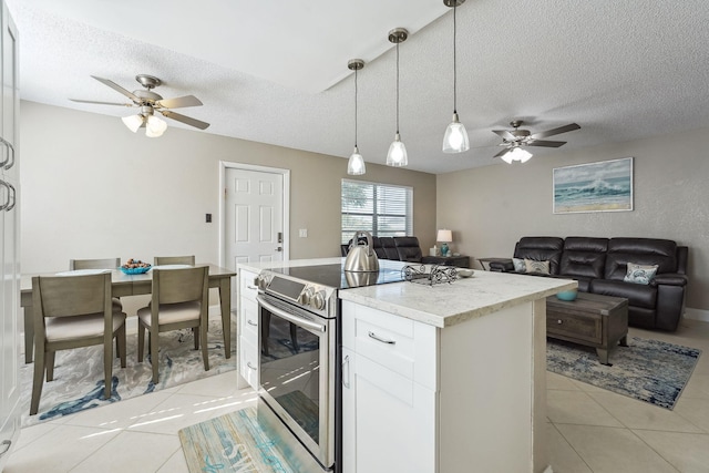 kitchen featuring stainless steel range with electric stovetop, a textured ceiling, light tile patterned floors, decorative light fixtures, and white cabinetry