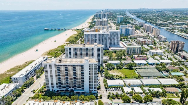 bird's eye view featuring a water view and a beach view