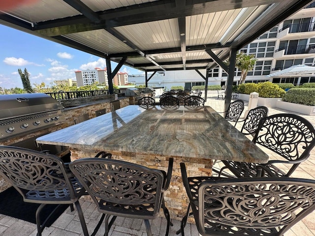 view of patio with exterior bar and an outdoor kitchen