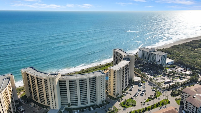 drone / aerial view featuring a water view and a beach view