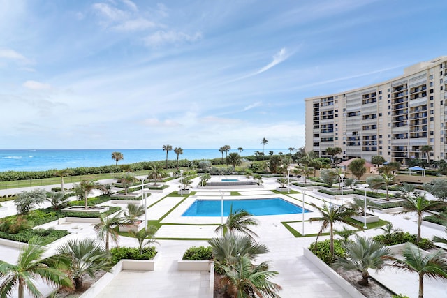 view of pool with a water view