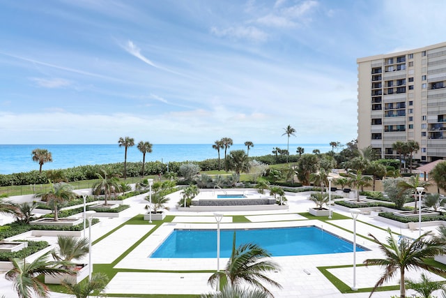 view of swimming pool with a water view