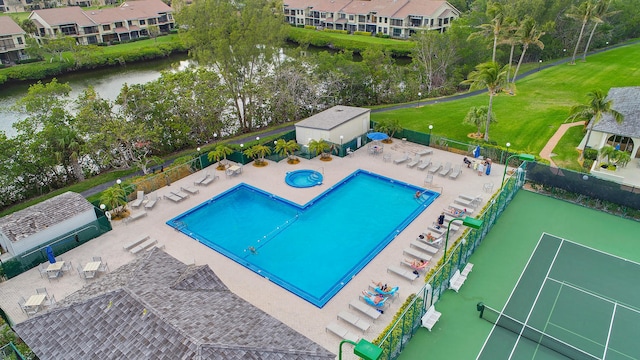 view of pool with a water view and tennis court