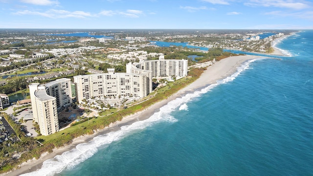 drone / aerial view featuring a water view and a view of the beach