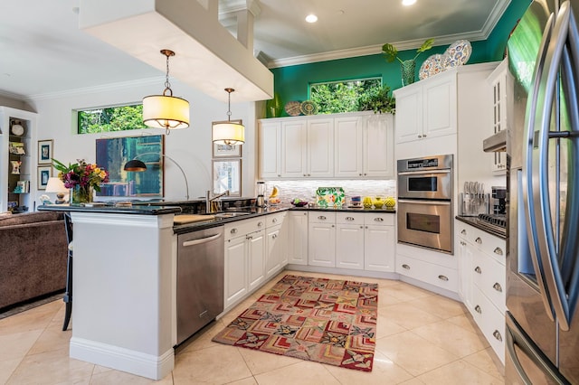 kitchen featuring white cabinets, stainless steel appliances, and ornamental molding