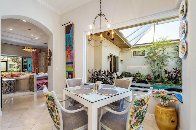 tiled dining space with a chandelier and crown molding