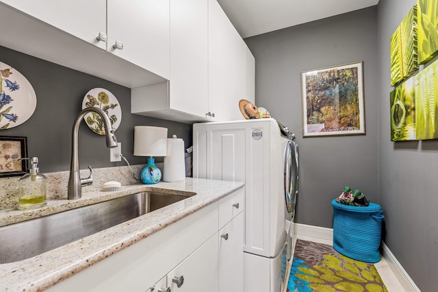 clothes washing area featuring sink, cabinets, and tile patterned flooring