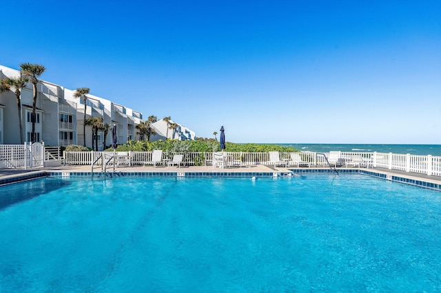 view of swimming pool with a water view