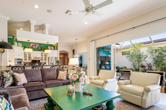 living room with ceiling fan and crown molding