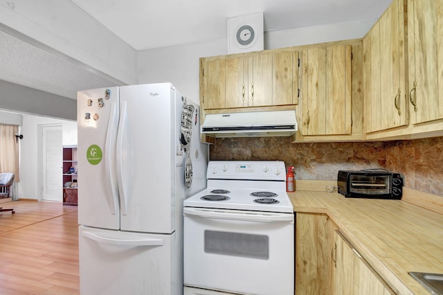 kitchen with white appliances, a toaster, extractor fan, light countertops, and light brown cabinetry