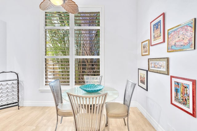 dining area with hardwood / wood-style flooring and plenty of natural light