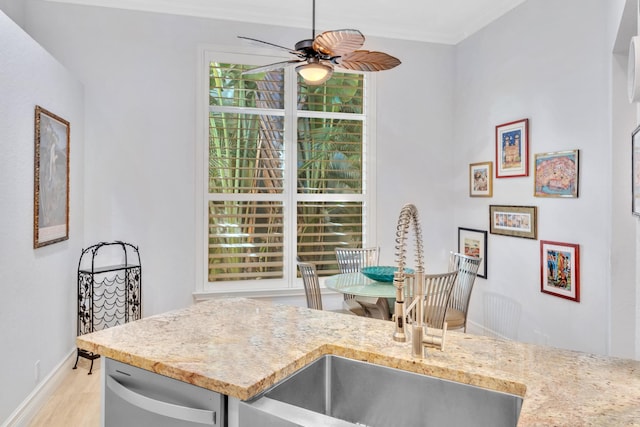 interior space featuring ceiling fan, sink, light hardwood / wood-style floors, and ornamental molding