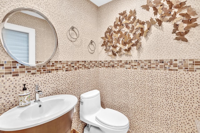 bathroom with tasteful backsplash, vanity, tile walls, and toilet