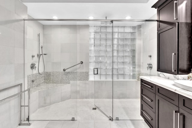 bathroom featuring tile patterned flooring, vanity, and a shower with shower door