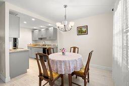 dining space with a notable chandelier and light hardwood / wood-style flooring