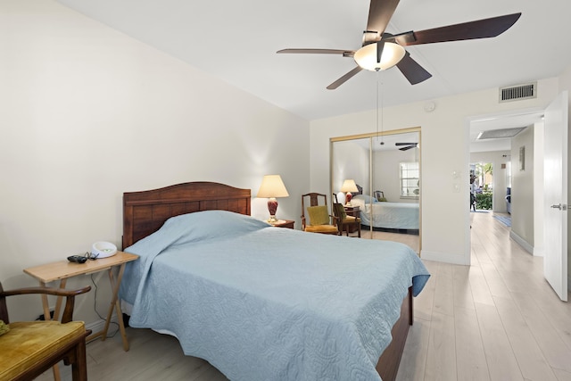 bedroom featuring a closet, ceiling fan, and light wood-type flooring