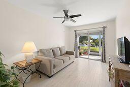 living room featuring ceiling fan and light wood-type flooring