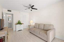 living room with ceiling fan and light hardwood / wood-style flooring