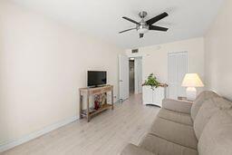 living room with ceiling fan and light hardwood / wood-style floors