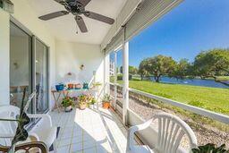 sunroom with a water view and ceiling fan