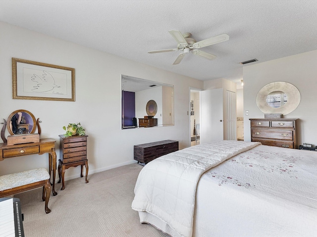 carpeted bedroom featuring ceiling fan, a textured ceiling, and a closet