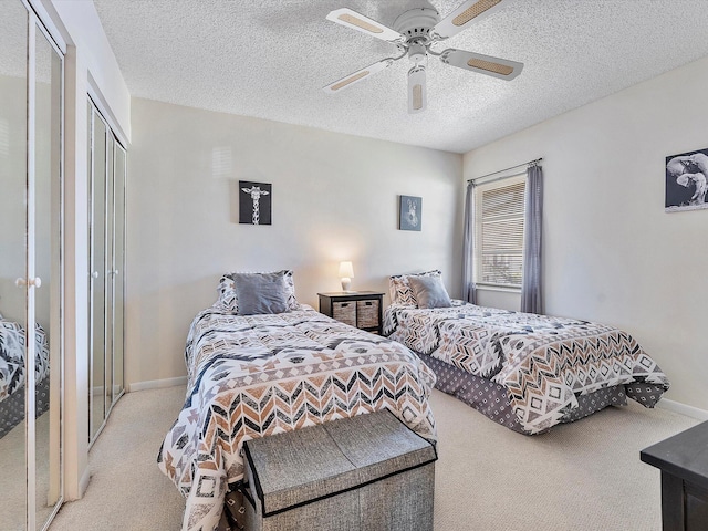 carpeted bedroom with a textured ceiling and ceiling fan