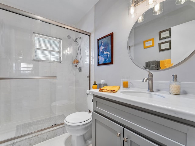 bathroom featuring tile patterned flooring, vanity, toilet, and a shower with shower door