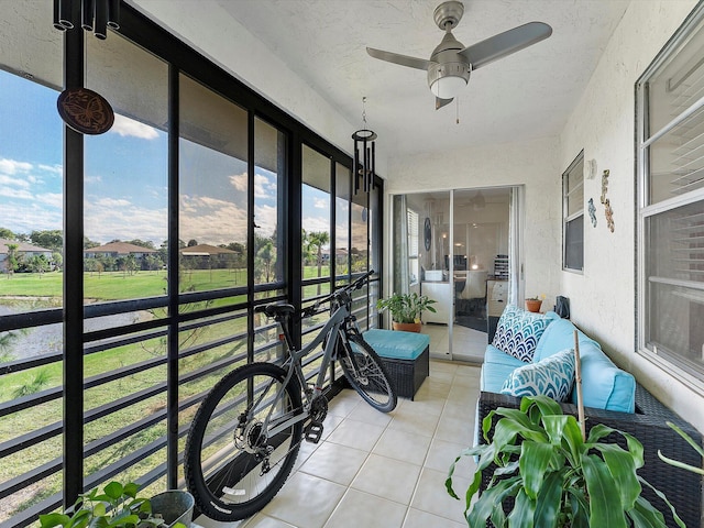 sunroom / solarium featuring ceiling fan