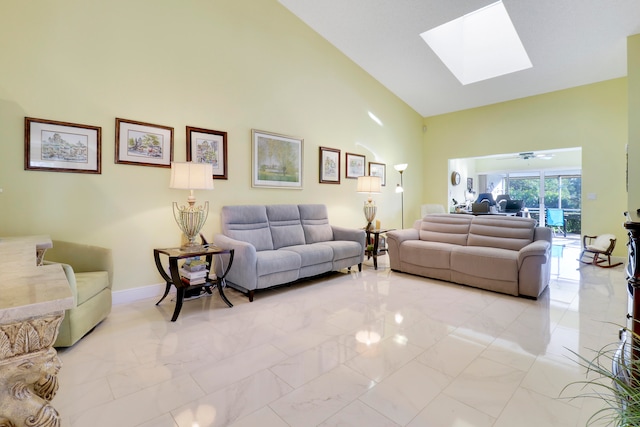 living room featuring ceiling fan, high vaulted ceiling, and a skylight